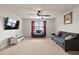 Spacious living room offers plenty of seating, a ceiling fan, and lots of natural light from a window at 8005 Caithness St, Raleigh, NC 27616
