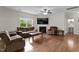 Cozy living room features a fireplace, ceiling fan, and comfortable seating, creating an inviting atmosphere at 8005 Caithness St, Raleigh, NC 27616