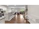 Open concept living space with wood floors connects kitchen, living and dining areas at 8005 Caithness St, Raleigh, NC 27616