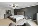 A spacious main bedroom featuring modern decor, neutral colors, ceiling fan, and elegant furnishings at 8005 Caithness St, Raleigh, NC 27616
