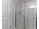 A clean, glass-enclosed shower with bright lighting, door, and modern fixtures at 8005 Caithness St, Raleigh, NC 27616