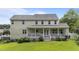 Covered back porch with white railings and steps leading to a large, grassy yard at 81 Northcliff Ct, Clayton, NC 27527