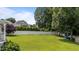 Spacious backyard featuring a privacy fence, lush grass, and mature trees at 81 Northcliff Ct, Clayton, NC 27527