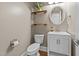 Modern half bath featuring decor shelving, modern fixtures and a white vanity at 81 Northcliff Ct, Clayton, NC 27527