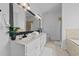 Bright bathroom with double sink vanity, large mirror and separate shower and soaking tub at 81 Northcliff Ct, Clayton, NC 27527