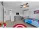 The bedroom has playful decor, a ceiling fan, and plenty of room for a children at 81 Northcliff Ct, Clayton, NC 27527