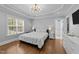 Primary bedroom with a trey ceiling, chandelier, hardwood floors and a view of the bathroom at 81 Northcliff Ct, Clayton, NC 27527