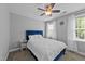 Cozy bedroom with a ceiling fan and bright windows providing natural light at 81 Northcliff Ct, Clayton, NC 27527