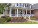Close up of charming covered front porch with columns and decorative details at 81 Northcliff Ct, Clayton, NC 27527