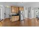View of the kitchen featuring wooden cabinets, hardwood floors and stainless refrigerator at 81 Northcliff Ct, Clayton, NC 27527