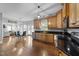 Kitchen area flows into the dining room with wooden cabinets, stainless appliances, and hardwood floors at 81 Northcliff Ct, Clayton, NC 27527