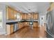 Spacious kitchen features wooden cabinets, stainless steel appliances, granite countertops and hardwood floors at 81 Northcliff Ct, Clayton, NC 27527
