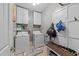 Functional laundry room with washer, dryer, and storage cabinets for supplies at 81 Northcliff Ct, Clayton, NC 27527