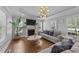 Cozy living room with a fireplace, large windows, and comfortable seating at 81 Northcliff Ct, Clayton, NC 27527