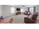 Spacious living room with plush carpet, large TV, and comfortable leather seating at 81 Northcliff Ct, Clayton, NC 27527