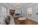 Bright living room with modern decor, hardwood floors, and a view of the kitchen at 81 Northcliff Ct, Clayton, NC 27527
