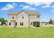 Expansive backyard with well-maintained lawn, showcasing the home's exterior and screened in porch at 81 Olive Branch Dr, Smithfield, NC 27577