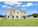 Two-story home showcasing a spacious backyard, complemented by lush green grass at 81 Olive Branch Dr, Smithfield, NC 27577