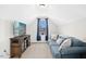 Cozy bonus room featuring a comfortable sofa, entertainment center, and a window with natural light at 81 Olive Branch Dr, Smithfield, NC 27577