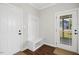 Bright entryway with wood floors, a storage bench, and access to front door and coat closet at 81 Olive Branch Dr, Smithfield, NC 27577