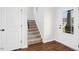 Inviting foyer featuring hardwood floors, staircase, and a glass-paneled front door at 81 Olive Branch Dr, Smithfield, NC 27577