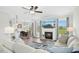 Bright living room with fireplace, ceiling fan, and an open view to the dining area at 81 Olive Branch Dr, Smithfield, NC 27577