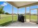 This screened porch has views of the level backyard, neighborhood, and blue skies at 81 Olive Branch Dr, Smithfield, NC 27577