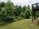 Expansive backyard features a lush lawn and mature trees, offering a serene outdoor space at 857 Stable Fern Dr, Fuquay Varina, NC 27526
