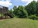 A lush backyard offers mature trees, green grass, and an open space for outdoor activities and enjoyment at 857 Stable Fern Dr, Fuquay Varina, NC 27526