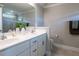 This bright bathroom boasts double sinks, white cabinets, framed mirrors, and modern fixtures at 857 Stable Fern Dr, Fuquay Varina, NC 27526