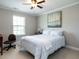 This bedroom is complete with a ceiling fan, a window for natural light, and neutral paint at 857 Stable Fern Dr, Fuquay Varina, NC 27526