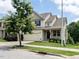 Charming two-story home featuring a welcoming front porch and attached two car garage at 857 Stable Fern Dr, Fuquay Varina, NC 27526