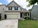 Charming two-story home featuring a welcoming front porch and attached two car garage at 857 Stable Fern Dr, Fuquay Varina, NC 27526