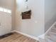 Welcoming foyer with light wood flooring, a decorative welcome sign, and staircase at 857 Stable Fern Dr, Fuquay Varina, NC 27526
