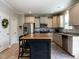 Kitchen with stainless appliances, a center island and granite counters is sure to delight at 857 Stable Fern Dr, Fuquay Varina, NC 27526