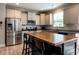 Spacious kitchen featuring stainless appliances, granite countertops, and a large center island at 857 Stable Fern Dr, Fuquay Varina, NC 27526