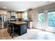 Bright kitchen features stainless appliances, a center island and access to an outdoor balcony at 857 Stable Fern Dr, Fuquay Varina, NC 27526