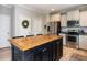 Kitchen with large center island and stainless appliances provides a great cooking experience at 857 Stable Fern Dr, Fuquay Varina, NC 27526