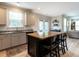Updated kitchen with a center island and stainless appliances flows to living area at 857 Stable Fern Dr, Fuquay Varina, NC 27526