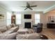 Spacious living room featuring a large sectional, fireplace, and natural light at 857 Stable Fern Dr, Fuquay Varina, NC 27526