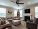 Living room includes a large sectional sofa, fireplace, TV, and traditional grandfather clock at 857 Stable Fern Dr, Fuquay Varina, NC 27526