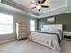 Large main bedroom with tray ceiling, and ceiling fan creates a relaxing retreat at 857 Stable Fern Dr, Fuquay Varina, NC 27526