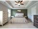 Main bedroom with tray ceiling, ceiling fan, and neutral colors to create a relaxing retreat at 857 Stable Fern Dr, Fuquay Varina, NC 27526