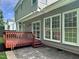 View of the backyard featuring a well-maintained deck, gray siding and neutral-colored patio at 8640 Swarthmore Dr, Raleigh, NC 27615