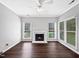 Bright empty basement featuring a fireplace and large windows overlooking the yard at 8640 Swarthmore Dr, Raleigh, NC 27615