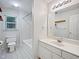 Bathroom with a toilet, bathtub, and white vanity with mirror and sconce lighting at 8640 Swarthmore Dr, Raleigh, NC 27615