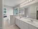 Bright bathroom with double sink vanity, large mirror, and soaking tub at 8640 Swarthmore Dr, Raleigh, NC 27615