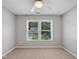 Neutral bedroom with a window view to the neighborhood at 8640 Swarthmore Dr, Raleigh, NC 27615