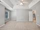 Spacious bedroom with plush carpeting, a ceiling fan, and a large window for natural light at 8640 Swarthmore Dr, Raleigh, NC 27615