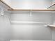 Spacious closet with white walls, wooden rods, and shelving at 8640 Swarthmore Dr, Raleigh, NC 27615